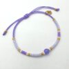 Verstelbare Ibiza armband in lavendel met jade kraal en rvs bloem bedel.